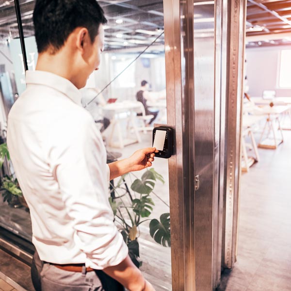 man using door access card reader